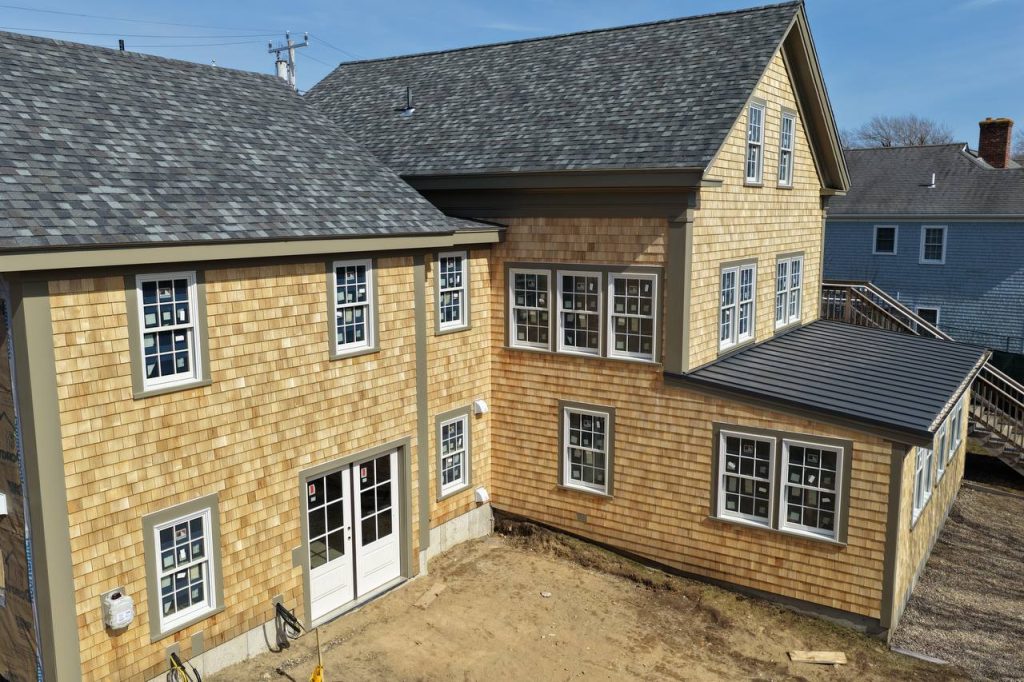 Side view showing cedar siding and exterior staircase